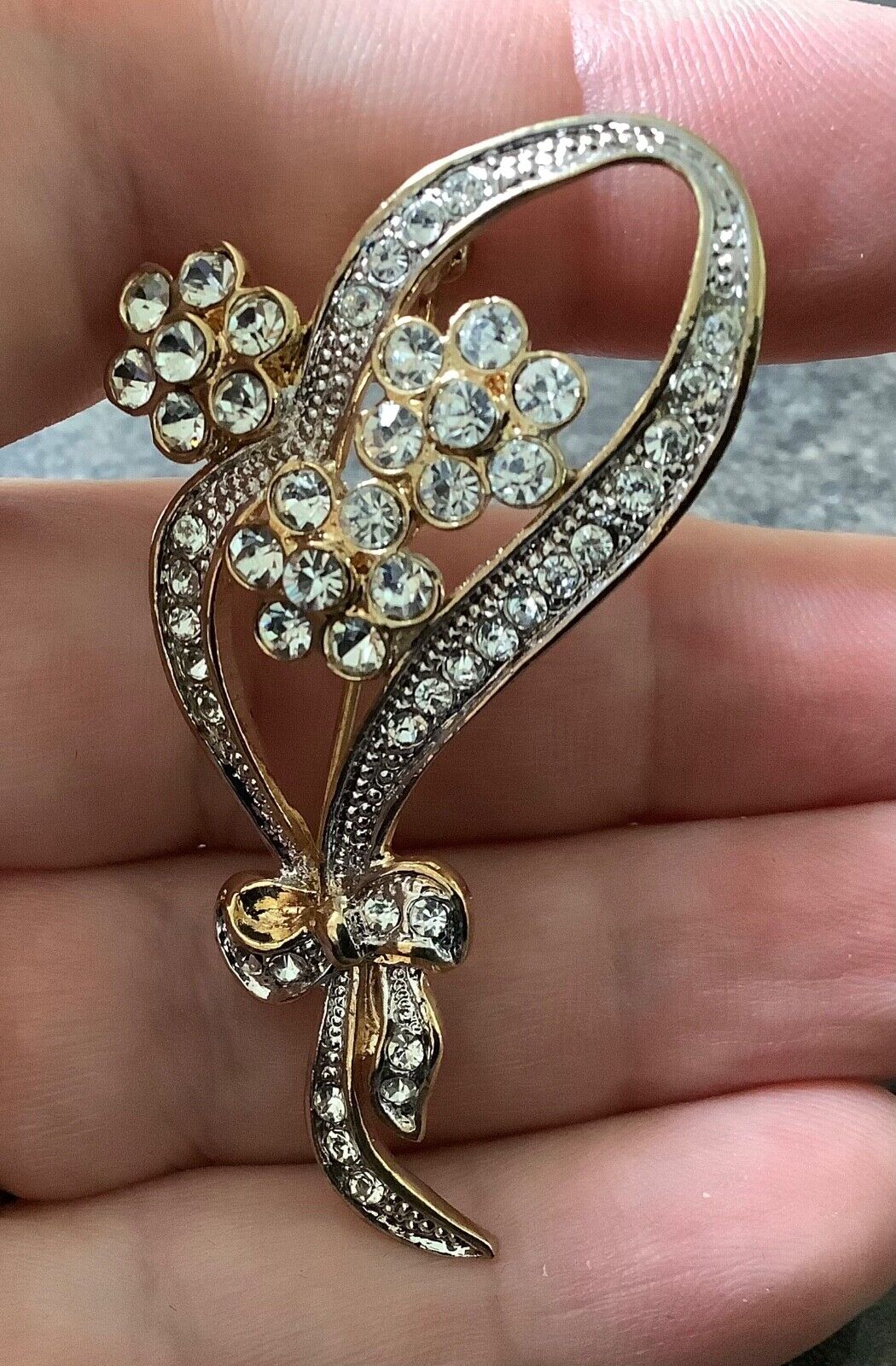 Adrian Buckley Pave Collection gold tone crystal flower on bow brooch