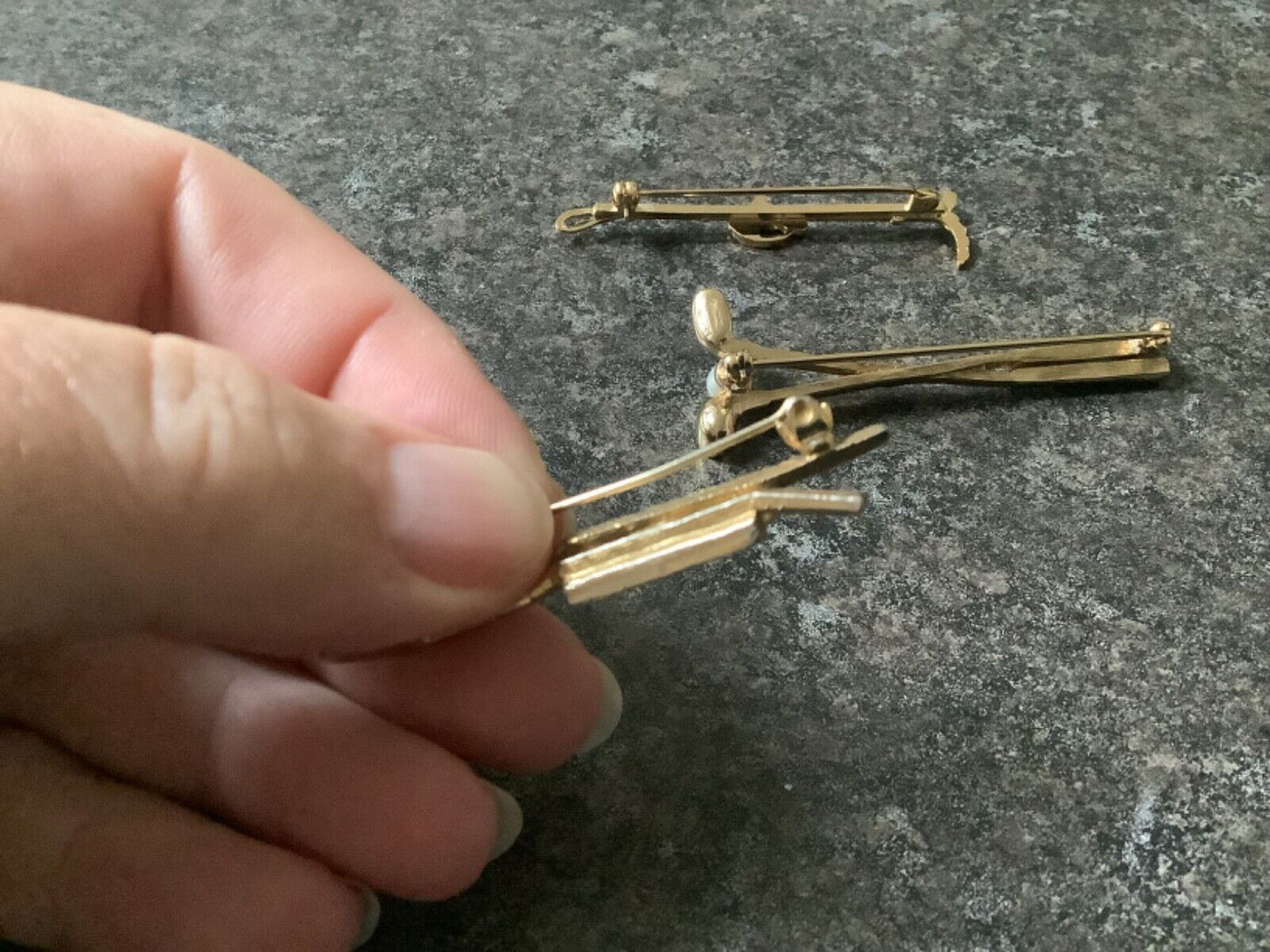3 gold tone brooches faux pearl and 19th hole golf clubs plus horse and crop