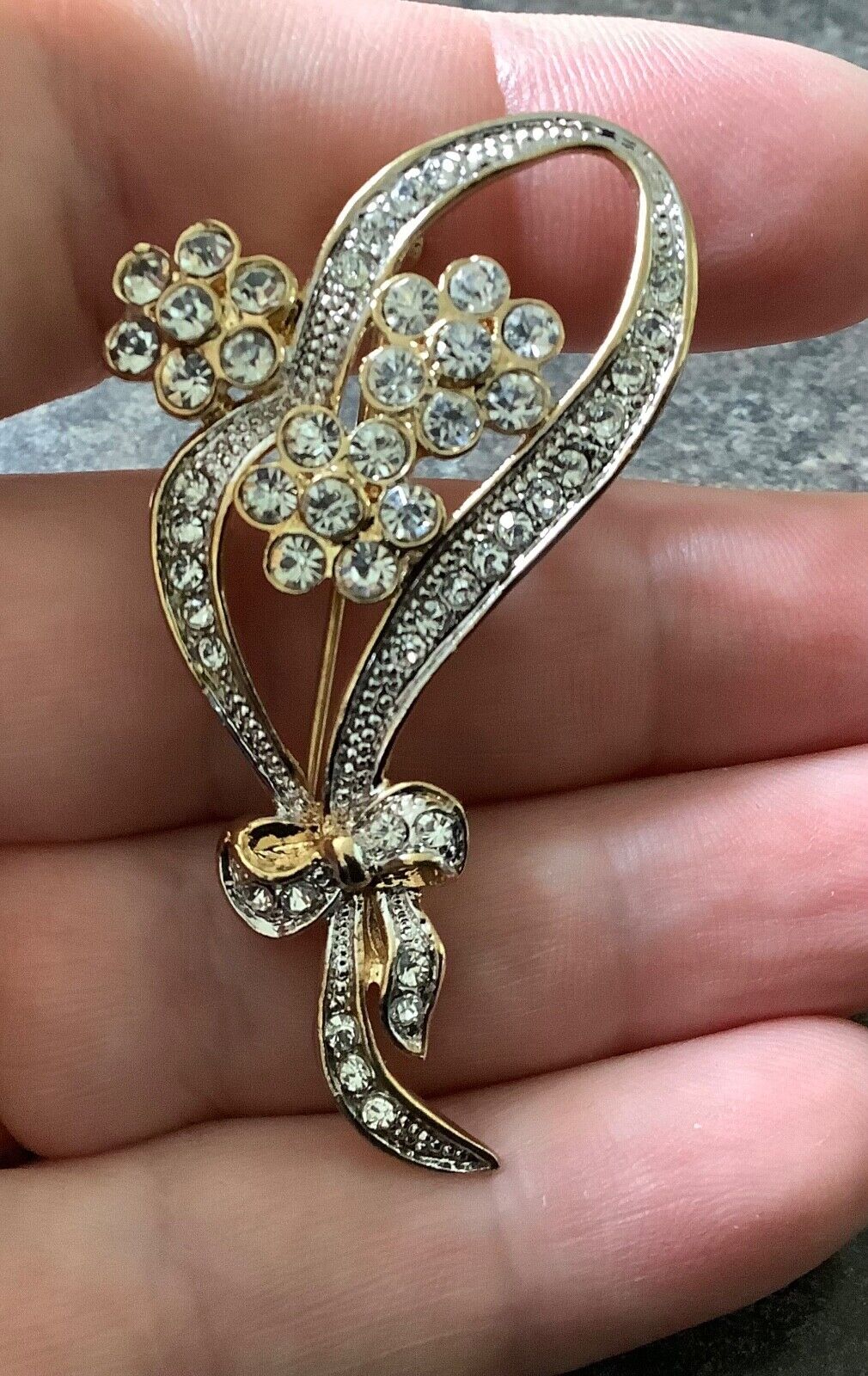 Adrian Buckley Pave Collection gold tone crystal flower on bow brooch