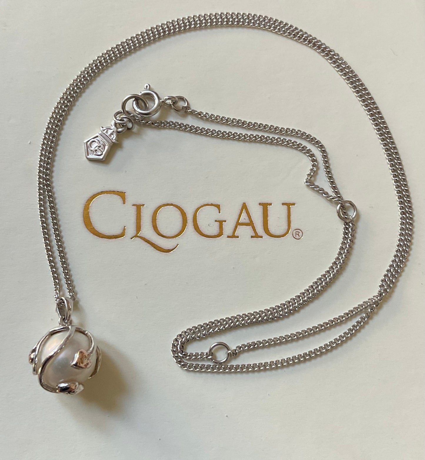 Clogau Caged Pearl stud earrings and Caged Pearl necklace in silver and rose gold