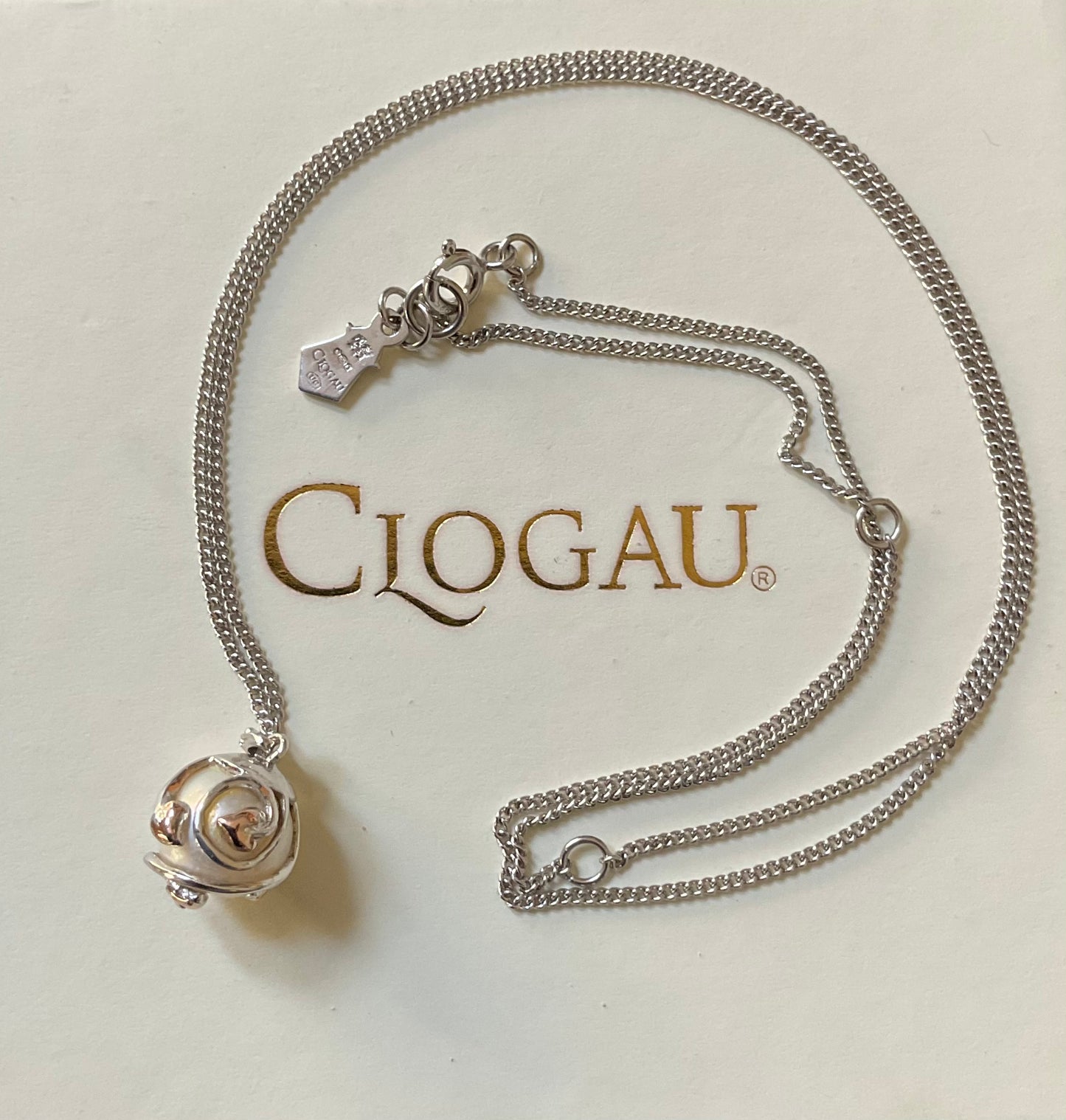 Clogau Caged Pearl stud earrings and Caged Pearl necklace in silver and rose gold