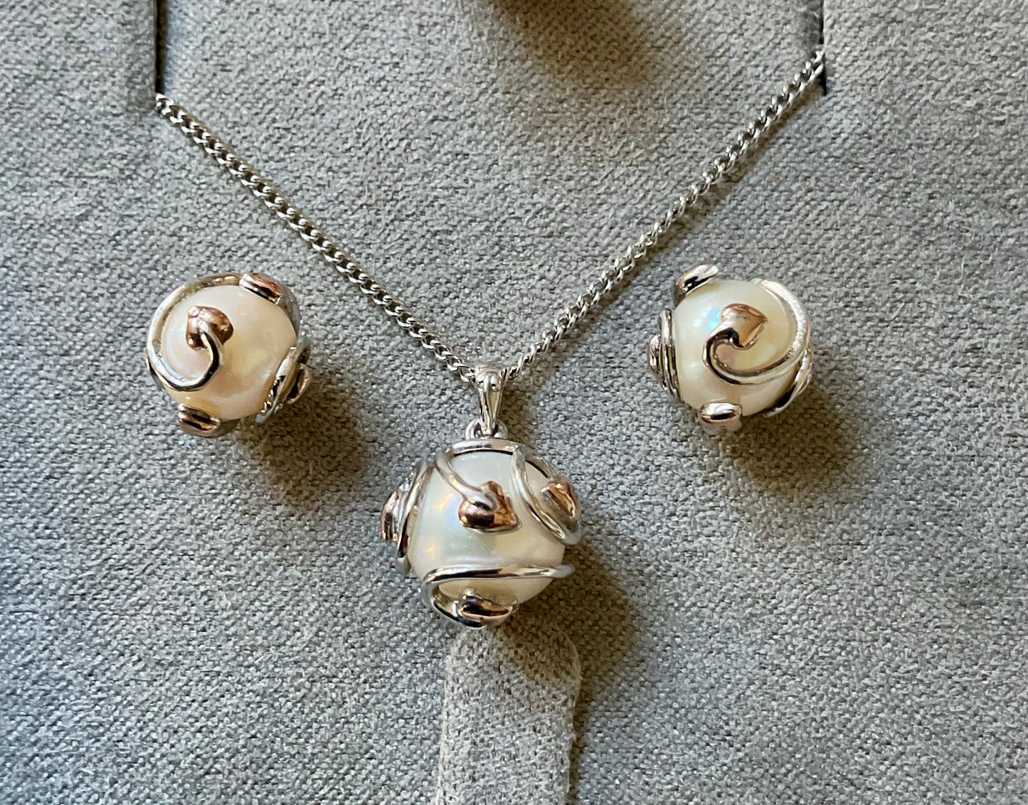 Clogau Caged Pearl stud earrings and Caged Pearl necklace in silver and rose gold