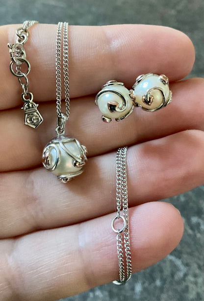 Clogau Caged Pearl stud earrings and Caged Pearl necklace in silver and rose gold