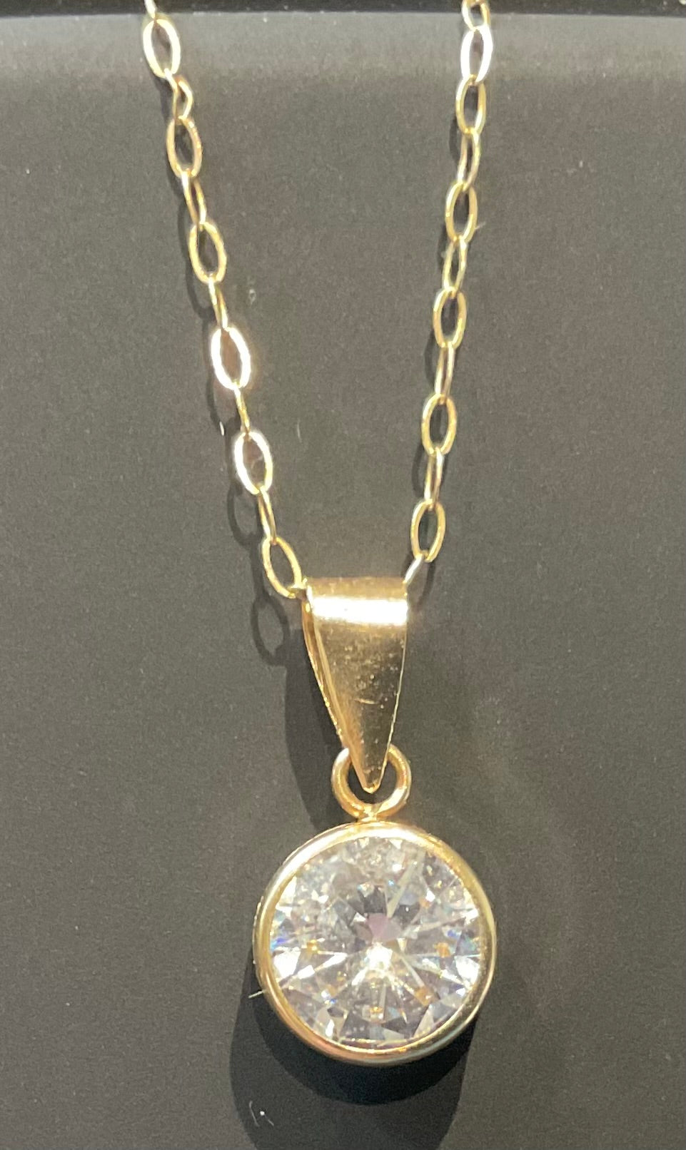 IBB 9ct Cubic Zirconia round bezel set solitaire pendant on 16" fine trace chain