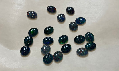 20 x triplet opal cabochons approximately 10x7mm flashes varied colours including reds greens yellows blues