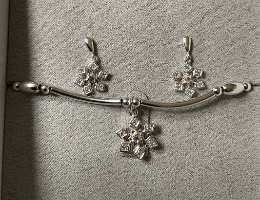 Clogau Snowflake drop earrings and Snowflake affinity stacking bracelet in silver and rose gold with white topaz