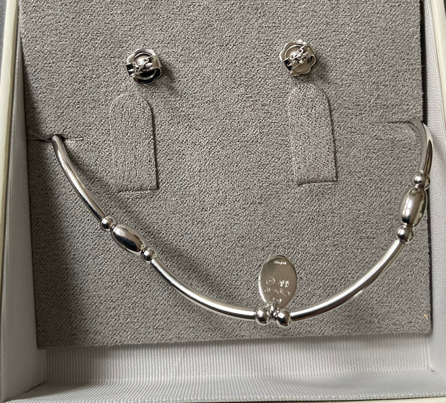 Clogau Snowflake drop earrings and Snowflake affinity stacking bracelet in silver and rose gold with white topaz