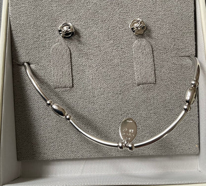 Clogau Snowflake drop earrings and Snowflake affinity stacking bracelet in silver and rose gold with white topaz