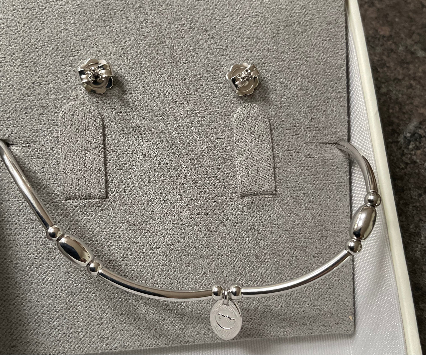 Clogau Snowflake drop earrings and Snowflake affinity stacking bracelet in silver and rose gold with white topaz