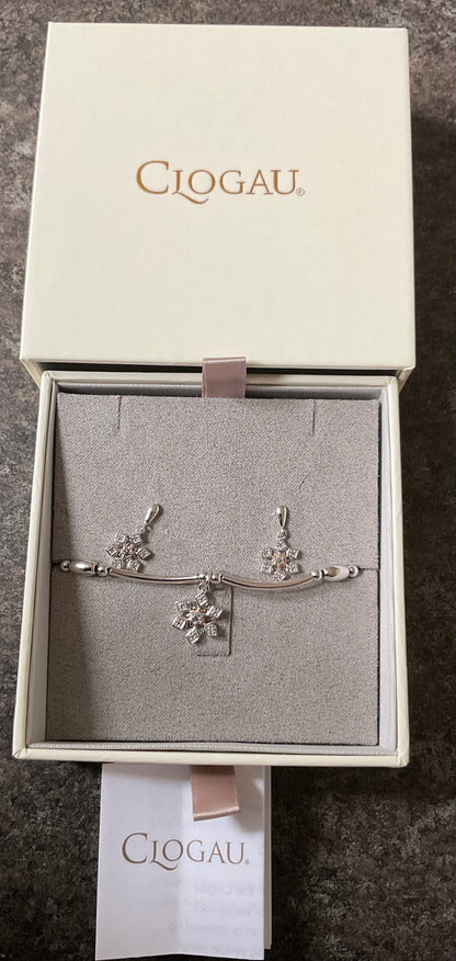 Clogau Snowflake drop earrings and Snowflake affinity stacking bracelet in silver and rose gold with white topaz