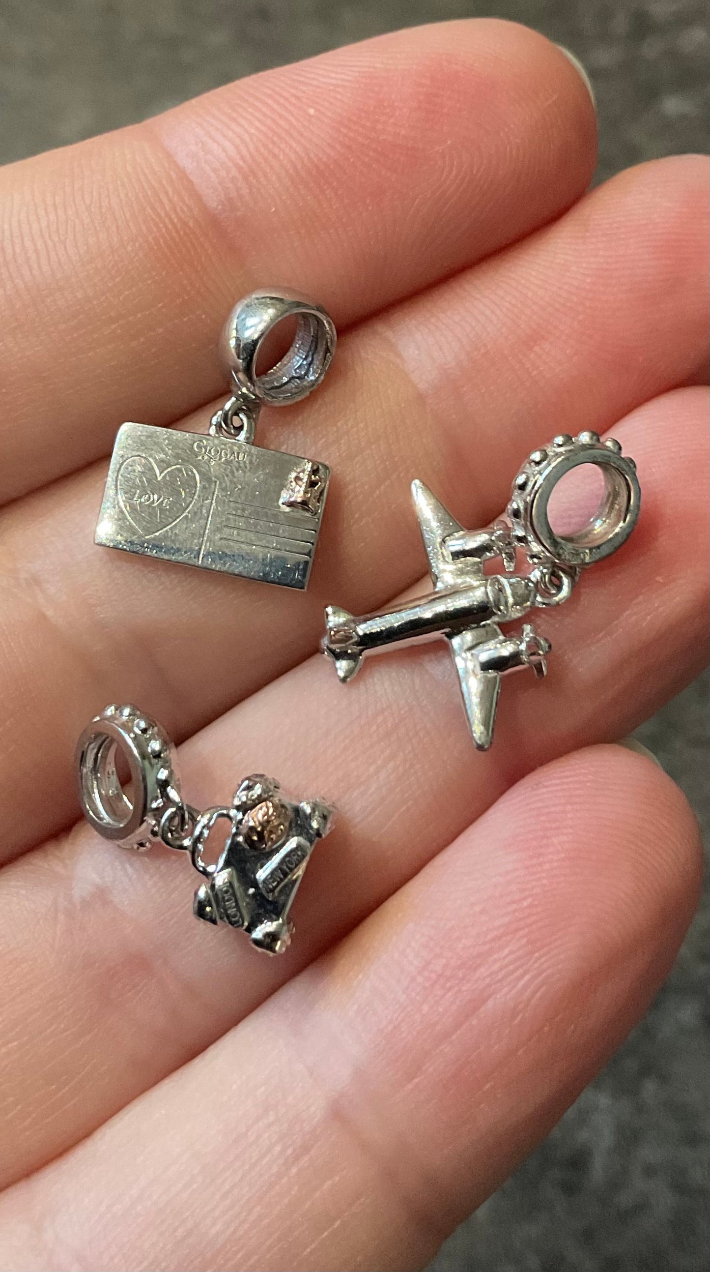 Clogau Suitcase, Postcard and Aeroplane Milestones charms in Silver and rose gold